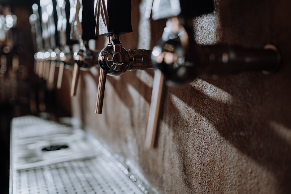 A row of beer taps behind a bar